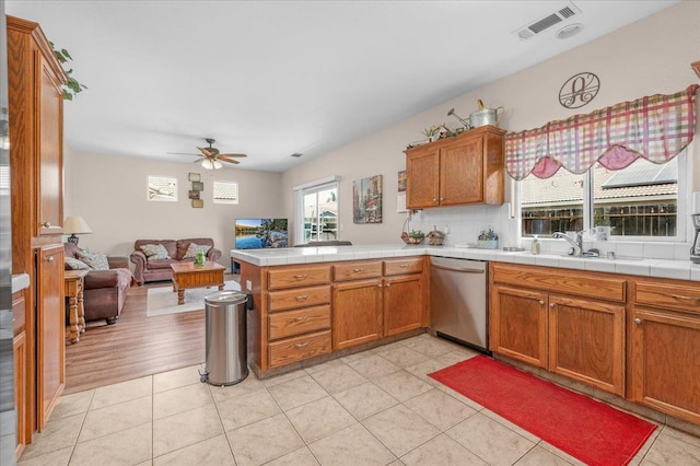 6164 W Keats, Fresno, CA 93723 - kitchen featuring ceiling fan, open floor plan, a peninsula, and brown cabinetry