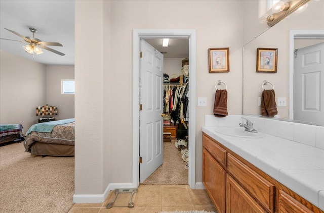 6164 W Keats, Fresno, CA 93723 - ensuite bathroom featuring vanity, ceiling fan, a walk in closet, and tile patterned flooring