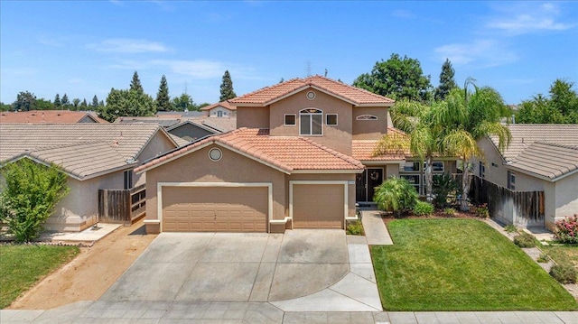 6164 W Keats, Fresno, CA 93723 - mediterranean / spanish home with stucco siding, concrete driveway, an attached garage, and a tile roof