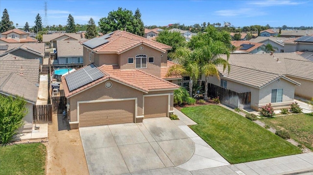 6164 W Keats, Fresno, CA 93723 - mediterranean / spanish home with a residential view, stucco siding, solar panels, and driveway