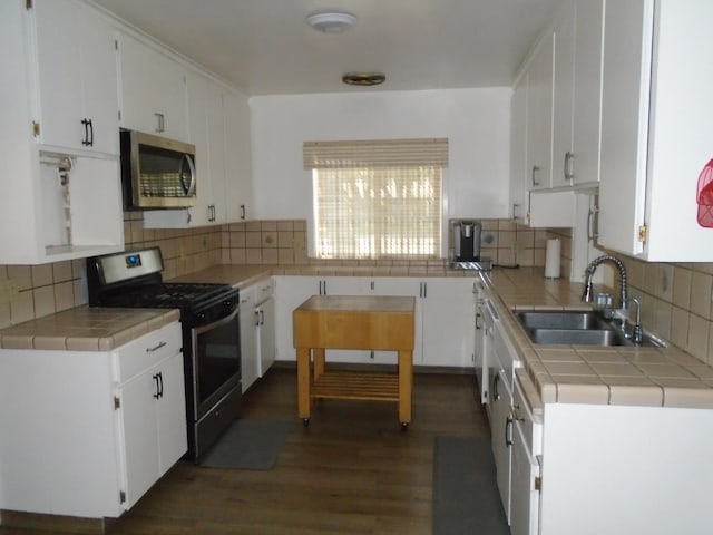 935 S Park Circle Dr, Fresno, CA 93727 - kitchen featuring appliances with stainless steel finishes, tile countertops, and white cabinetry