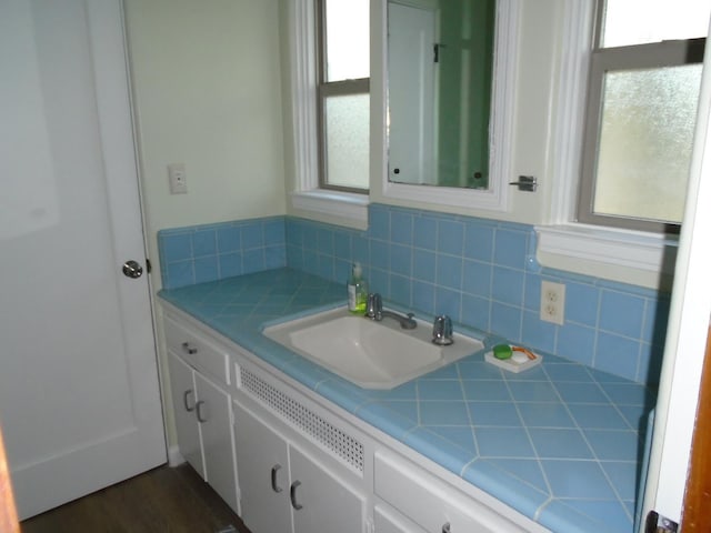 935 S Park Circle Dr, Fresno, CA 93727 - bathroom with vanity, healthy amount of natural light, and tasteful backsplash