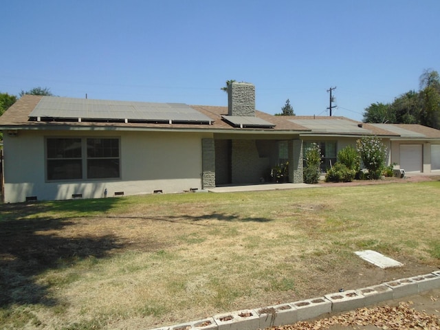 935 S Park Circle Dr, Fresno, CA 93727 - view of front of property featuring a front yard, solar panels, and a garage