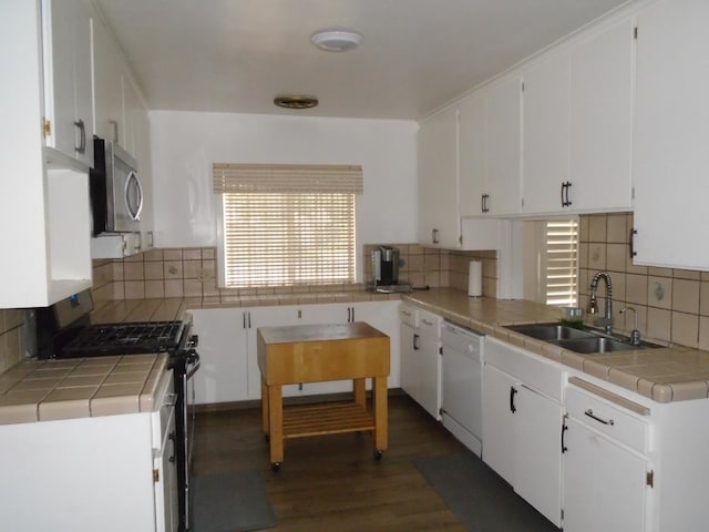 935 S Park Circle Dr, Fresno, CA 93727 - kitchen with appliances with stainless steel finishes, tile countertops, backsplash, and white cabinetry