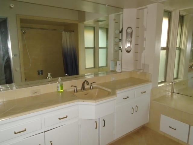 935 S Park Circle Dr, Fresno, CA 93727 - bathroom with double vanity, healthy amount of natural light, and a shower with curtain