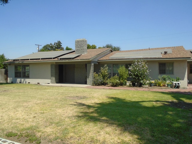 935 S Park Circle Dr, Fresno, CA 93727 - view of front of home with roof mounted solar panels, stucco siding, and a front lawn