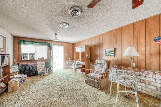 25 W Dinuba Ave, Fresno, CA 93706 - living room featuring carpet, a textured ceiling, and wooden walls