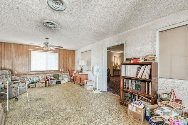 25 W Dinuba Ave, Fresno, CA 93706 - sitting room featuring carpet flooring, ceiling fan, wooden walls, a textured ceiling, and a textured wall