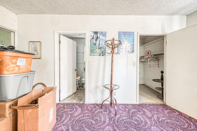 25 W Dinuba Ave, Fresno, CA 93706 - carpeted bedroom with a textured ceiling, a walk in closet, and connected bathroom