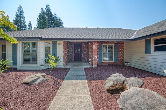 591 E Warwick Ave, Fresno, CA 93720 - ranch-style house featuring roof with shingles, covered porch, and brick siding