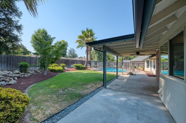 591 E Warwick Ave, Fresno, CA 93720 - fenced backyard with a patio area and ceiling fan