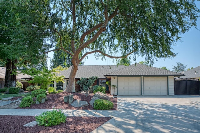 591 E Warwick Ave, Fresno, CA 93720 - ranch-style house featuring concrete driveway, a garage, and a shingled roof