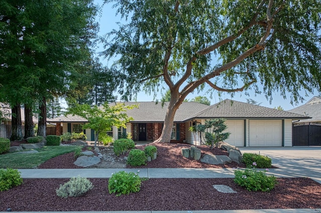 591 E Warwick Ave, Fresno, CA 93720 - ranch-style house featuring a garage, concrete driveway, and roof with shingles