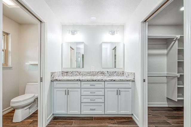 591 E Warwick Ave, Fresno, CA 93720 - full bathroom with double vanity, wood tiled floors, and a spacious closet