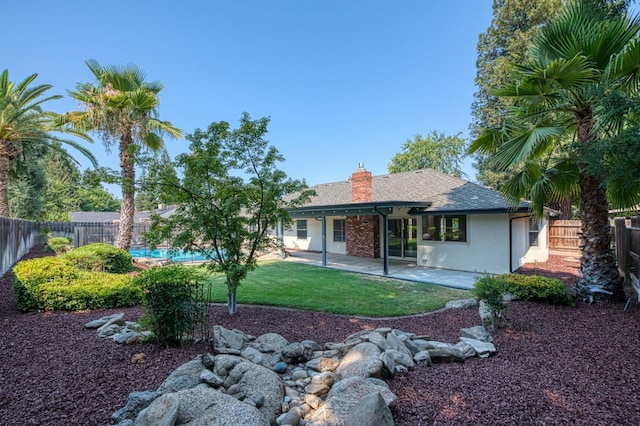 591 E Warwick Ave, Fresno, CA 93720 - back of house with a fenced backyard, a patio area, a shingled roof, a chimney, and stucco siding