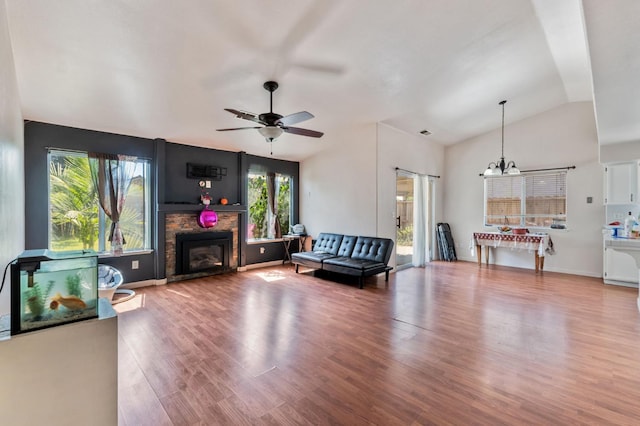539 Chablis Ave, Madera, CA 93637 - living room featuring a fireplace, wood finished floors, a chandelier, ceiling fan, and lofted ceiling