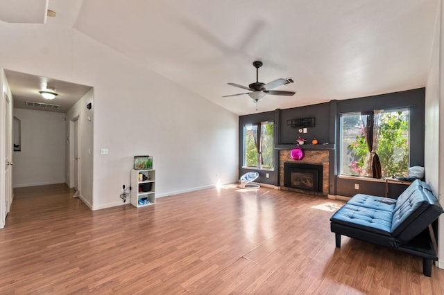539 Chablis Ave, Madera, CA 93637 - living room with light wood-type flooring, a stone fireplace, and a ceiling fan
