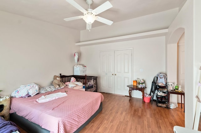 539 Chablis Ave, Madera, CA 93637 - bedroom with a closet, light wood finished floors, arched walkways, and a ceiling fan