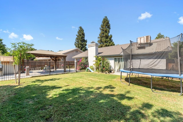 539 Chablis Ave, Madera, CA 93637 - fenced backyard featuring a gazebo, a trampoline, and a patio