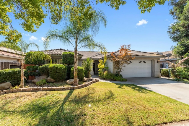539 Chablis Ave, Madera, CA 93637 - view of front of property with a garage, concrete driveway, a tiled roof, and stucco siding