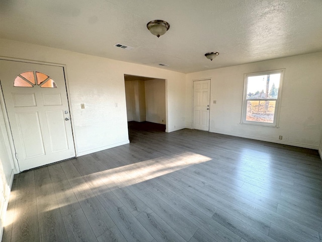 1741 N Blythe Ave, Fresno, CA 93722 - unfurnished living room with wood finished floors and a textured ceiling