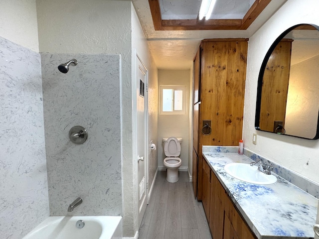 1741 N Blythe Ave, Fresno, CA 93722 - bathroom with vanity, wood finished floors, bathing tub / shower combination, and a textured wall
