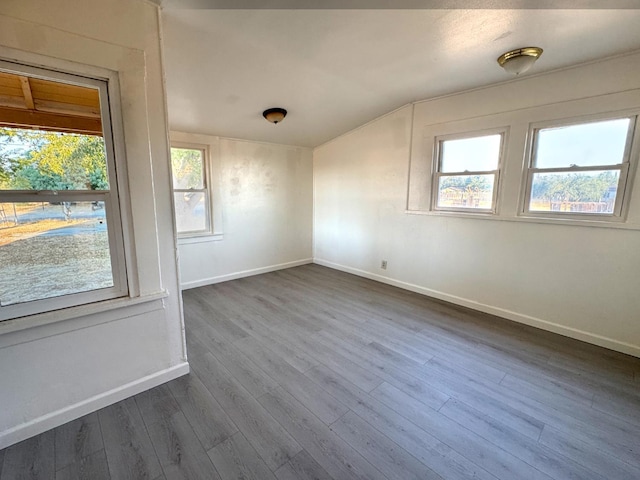 1741 N Blythe Ave, Fresno, CA 93722 - spare room featuring dark wood-style flooring and lofted ceiling
