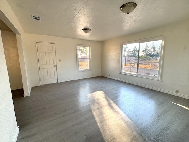 1741 N Blythe Ave, Fresno, CA 93722 - spare room with dark wood-type flooring and a textured ceiling