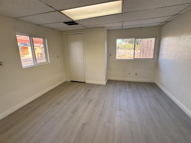 1741 N Blythe Ave, Fresno, CA 93722 - unfurnished bedroom featuring a paneled ceiling, wood finished floors, and multiple windows