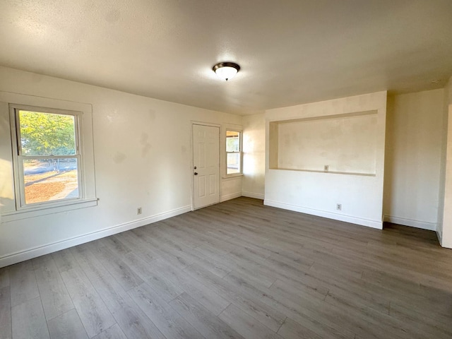 1741 N Blythe Ave, Fresno, CA 93722 - empty room with dark wood-type flooring and plenty of natural light