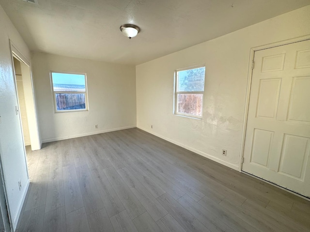 1741 N Blythe Ave, Fresno, CA 93722 - unfurnished bedroom with dark wood-style floors and multiple windows