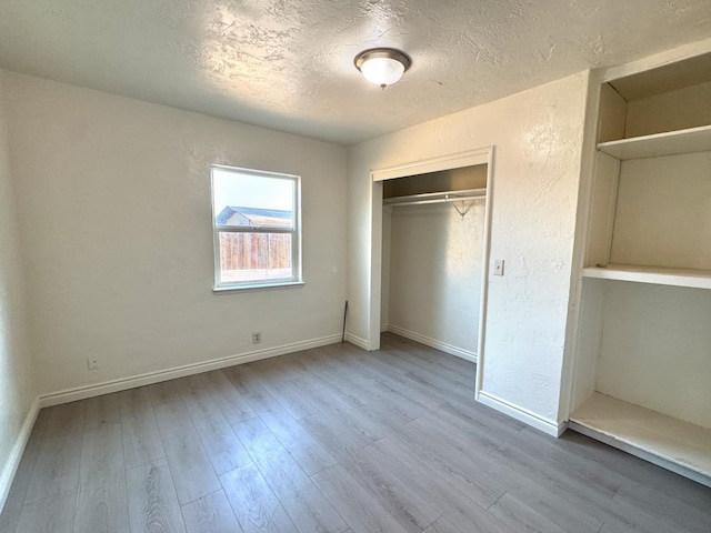 1741 N Blythe Ave, Fresno, CA 93722 - unfurnished bedroom with a textured ceiling, wood finished floors, and a closet