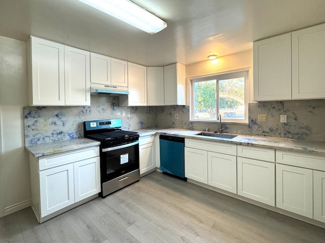1741 N Blythe Ave, Fresno, CA 93722 - kitchen with stainless steel range with gas cooktop, light wood-type flooring, white cabinets, dishwasher, and decorative backsplash