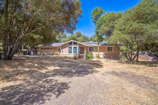 31736 Apache Rd, Coarsegold, CA 93614 - ranch-style home featuring solar panels, an attached garage, and driveway