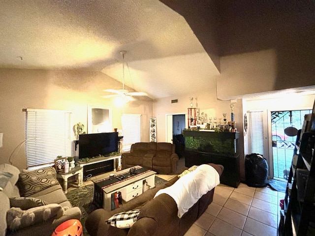 3315 Dewey Ave, Fresno, CA 93722 - tiled living area with vaulted ceiling, ceiling fan, and a textured ceiling