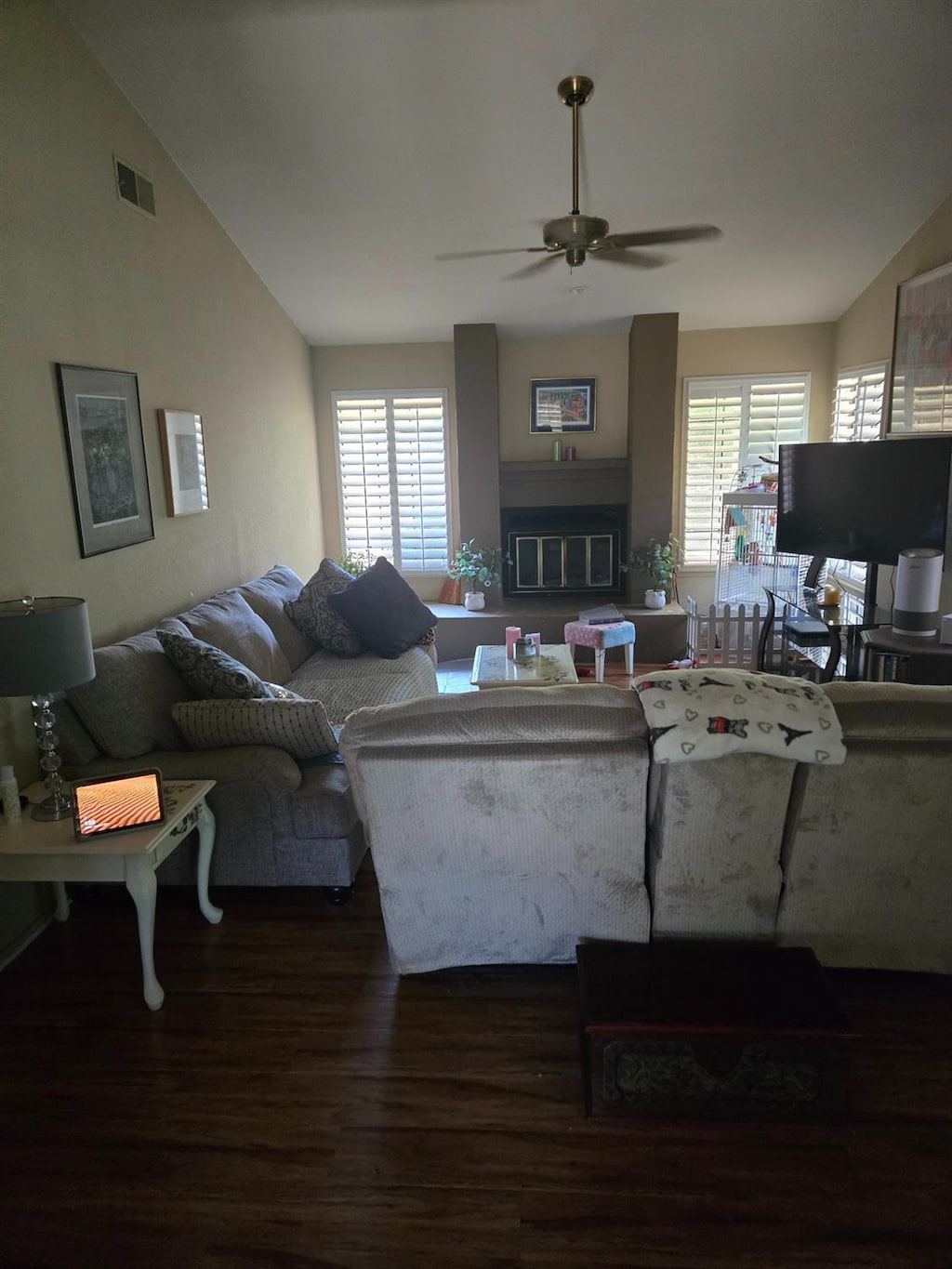 7762 N 7th St, Fresno, CA 93720 - living area featuring lofted ceiling, wood finished floors, a ceiling fan, plenty of natural light, and a glass covered fireplace