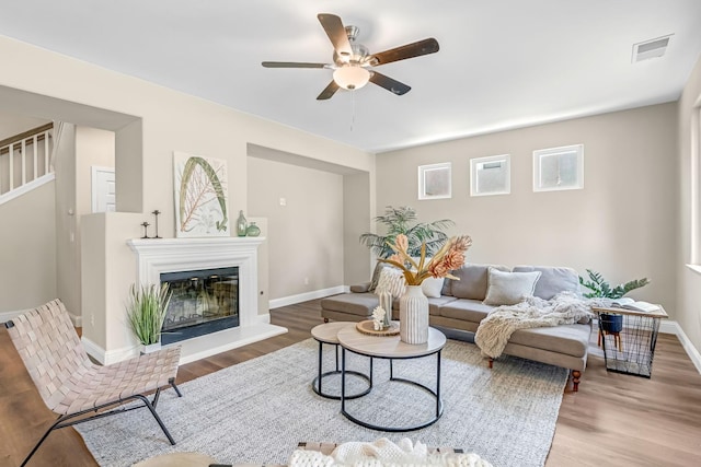 2234 E Serena Ave, Fresno, CA 93720 - living room featuring a ceiling fan, wood finished floors, stairs, and a glass covered fireplace