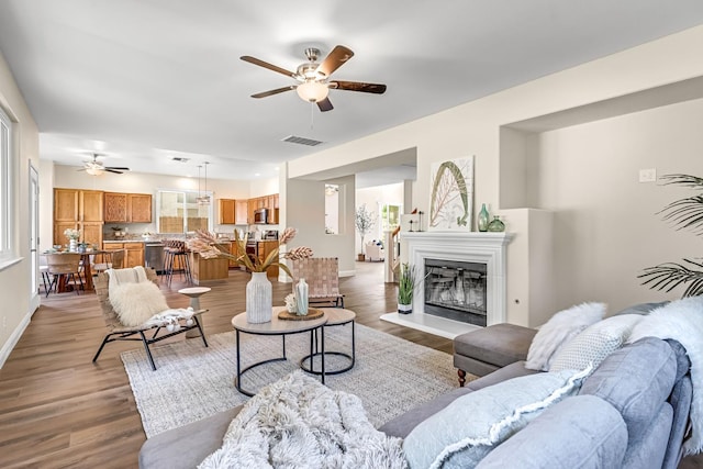 2234 E Serena Ave, Fresno, CA 93720 - living area featuring ceiling fan, light wood-type flooring, and a glass covered fireplace