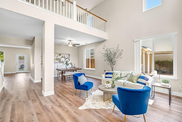 2234 E Serena Ave, Fresno, CA 93720 - living room featuring light wood-style floors, a towering ceiling, and ceiling fan