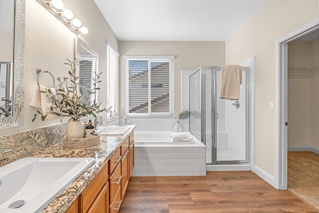 2234 E Serena Ave, Fresno, CA 93720 - full bathroom with a garden tub, a stall shower, double vanity, wood finished floors, and a walk in closet