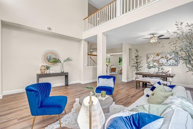 2234 E Serena Ave, Fresno, CA 93720 - living area featuring wood finished floors, a ceiling fan, stairs, and a high ceiling