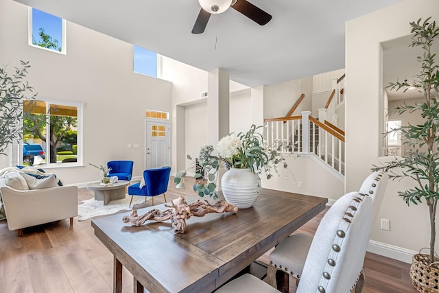 2234 E Serena Ave, Fresno, CA 93720 - dining space with ceiling fan, stairway, wood finished floors, and a towering ceiling