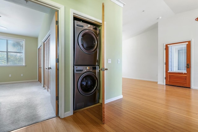 2658 E Alluvial Ave Unit 220, Fresno, CA 93720 - washroom featuring stacked washing machine and dryer and light wood-type flooring