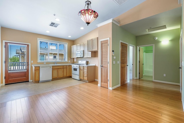 2658 E Alluvial Ave Unit 220, Fresno, CA 93720 - kitchen featuring white appliances, light countertops, light wood-style floors, decorative light fixtures, and light brown cabinetry