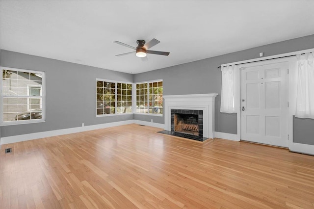 1461 N Harrison Ave, Fresno, CA 93728 - unfurnished living room with ceiling fan, wood finished floors, and a tile fireplace