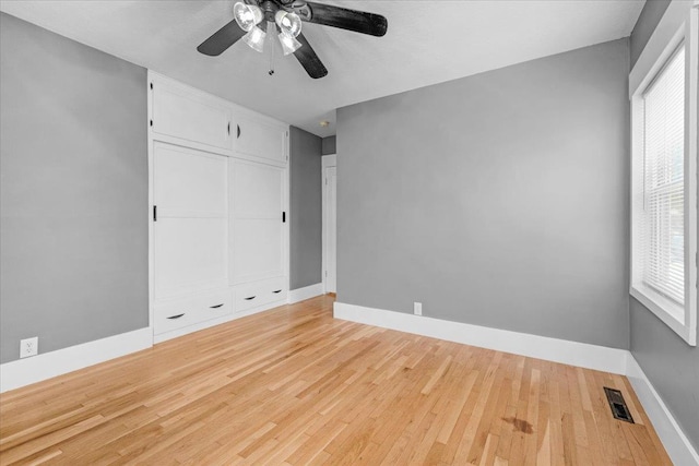 1461 N Harrison Ave, Fresno, CA 93728 - unfurnished bedroom featuring wood finished floors, a closet, and a ceiling fan