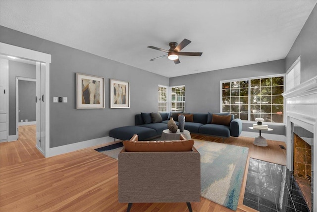 1461 N Harrison Ave, Fresno, CA 93728 - living room with ceiling fan, a fireplace with flush hearth, and wood finished floors