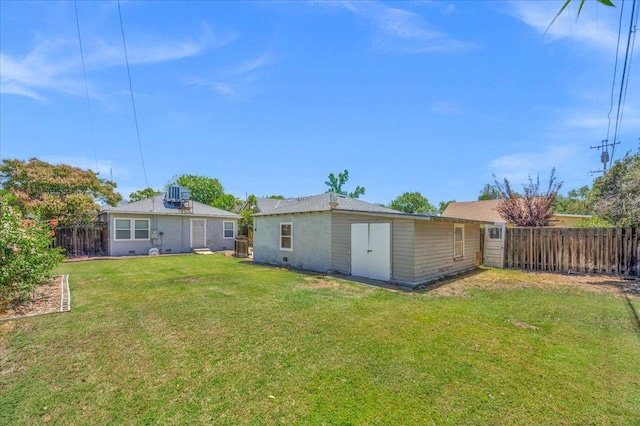 1461 N Harrison Ave, Fresno, CA 93728 - rear view of house with a fenced backyard and an outdoor structure