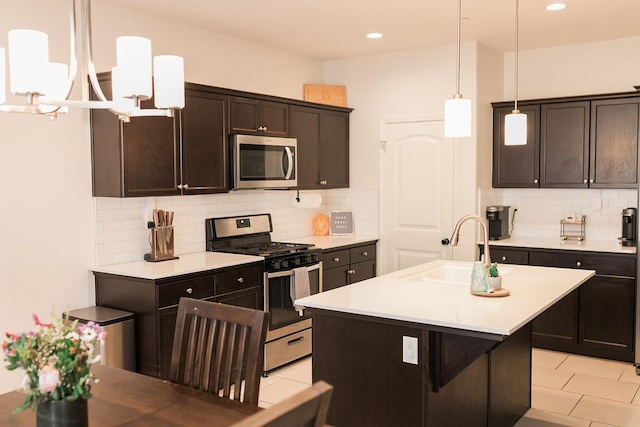 4438 N Sandrini Ave, Fresno, CA 93723 - kitchen featuring appliances with stainless steel finishes, light countertops, decorative backsplash, dark brown cabinets, and recessed lighting