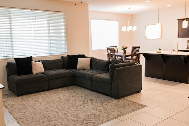 4438 N Sandrini Ave, Fresno, CA 93723 - living room featuring light tile patterned floors and a chandelier